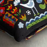 Colorful cushion cover with floral, bird, and human patterns, featuring a hidden zipper.