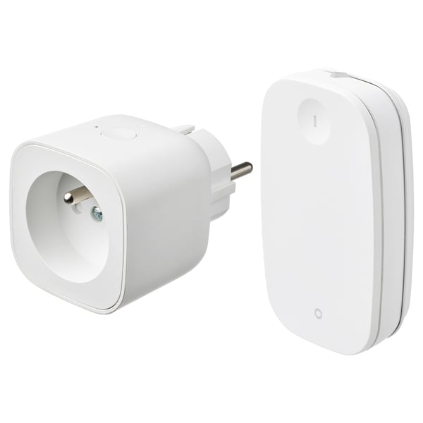 Displays two white smart home devices: a plug adapter and a remote control, both sleek and minimalist.