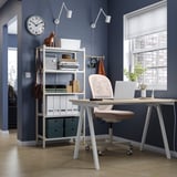 Home office: desk, chair, shelves, laptop, plant, clock