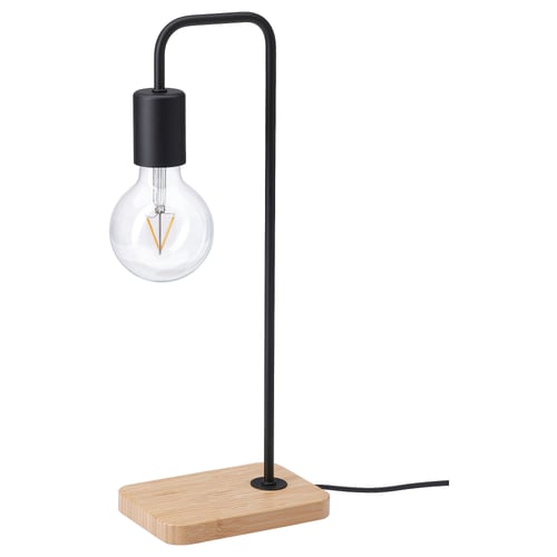 A modern black lamp named TVÄRHAND with a bamboo base, featuring a clear bulb.