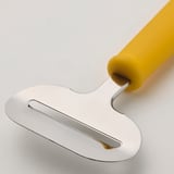 A lightweight plastic cheese slicer with a bright yellow handle and stainless steel blade, designed for easy use and cleaning.