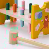 Wooden childrens hammer toy with colorful pegs; high-quality construction and vibrant illustrations.
