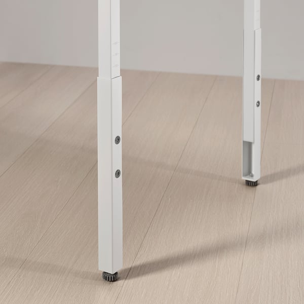 Adjustable gaming desk legs with white metal, two height knobs, and black feet for stability.