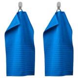 Two blue VÅGSJÖN towels hang neatly from silver hooks, showcasing their textured, ribbed design and soft cotton material.