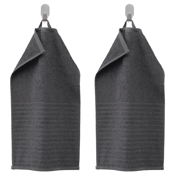 Two dark gray VÅGSJÖN towels hang side by side, featuring a striped design with a solid terry texture. Made of 100% cotton.