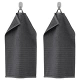 Two dark gray VÅGSJÖN towels hang side by side, featuring a striped design with a solid terry texture. Made of 100% cotton.