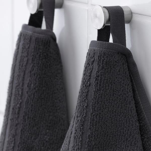 Black towels hanging: soft, absorbent cotton; medium weight, quick-dry stripes.
