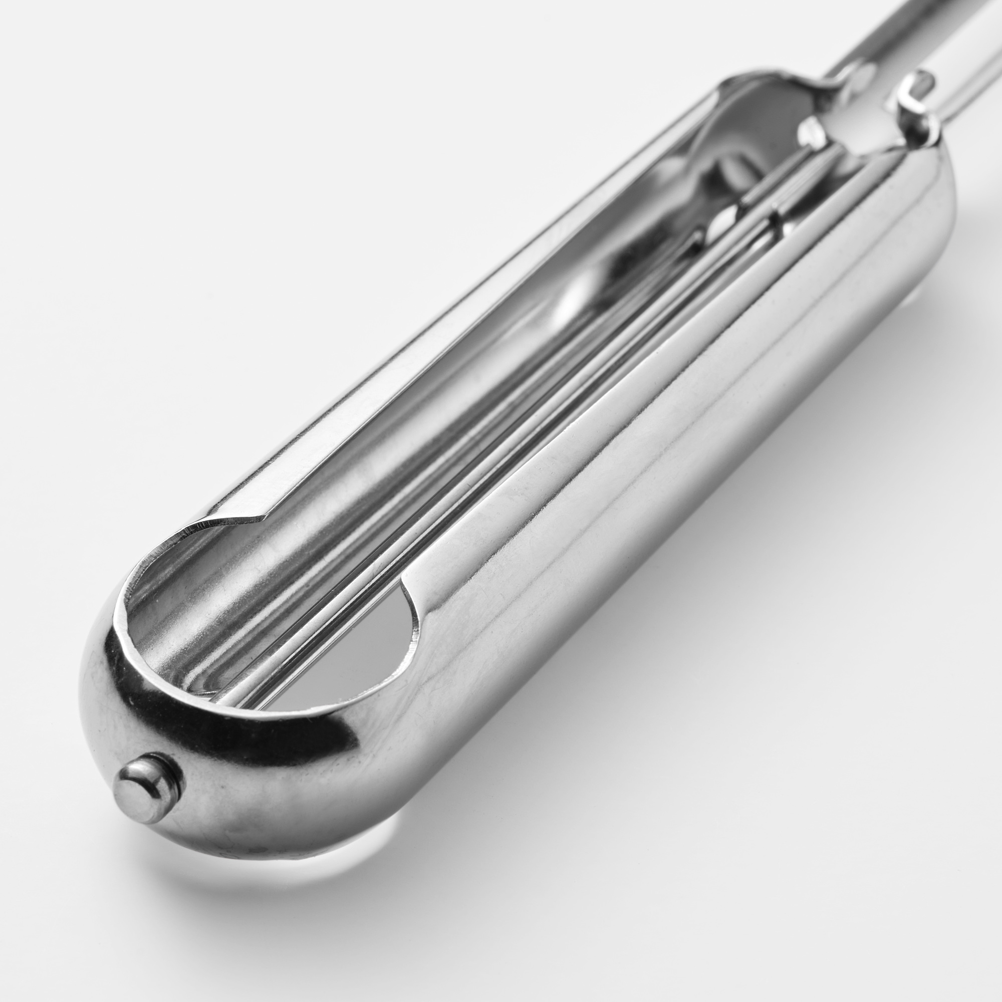 Silver stainless steel potato peeler with smooth surface, sharp blade, round end, and sleek design.