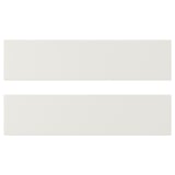White VEDDINGE kitchen cabinets, sleek and modern. Made from fibreboard and polyurethane paint, rectangular shape.