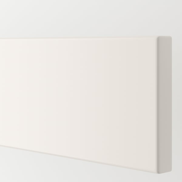Close-up of VEDDINGE kitchen cabinet in pristine white, showing smooth, clean lines and flawless finish.