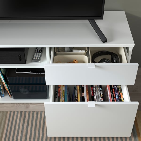 Modern white tv stand with open and closed storage spaces, featuring drawers and compartments for electronics and media, organized neatly.