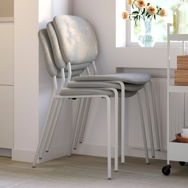 Stackable dining chairs with foam seats and backs, ideal for compact living.