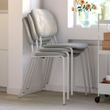 Stackable dining chairs with foam seats and backs, ideal for compact living.