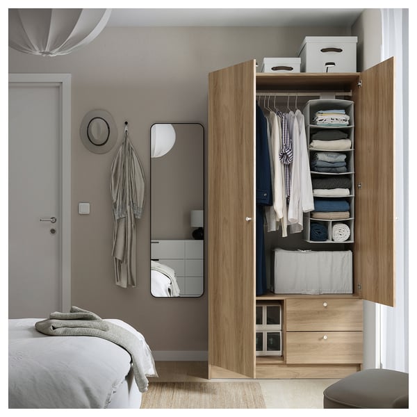 An open VILHATTEN wardrobe in a bedroom, organizing clothes and items.