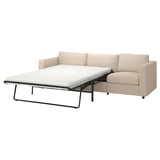 Modern beige sofa-bed with mock cushion design and metal legs.