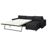 Black corner sofa bed, contemporary design, with extendable chaise longue.