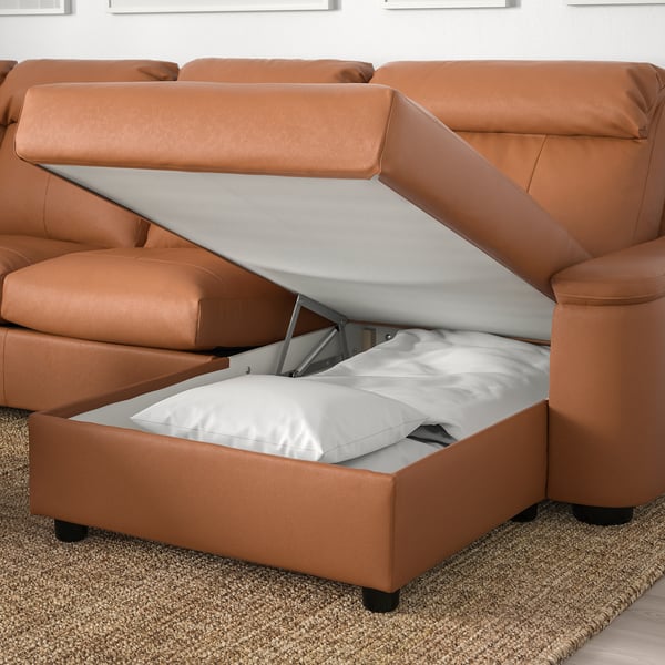 Sofa with raised ottoman storage, revealing hidden space.