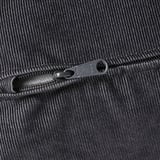 Black zipper on a textured, ribbed fabric surface, showcasing high-quality construction and design detail.