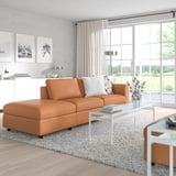 VIMLE orange l-sofa, clean lines, plush cushions, white coffee table, natural light.