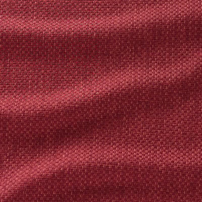 It shows textured red fabric, likely from a couch or sofa.
