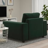 Dark green VIMLE sofa with armrest and side table holding a mug and coaster.