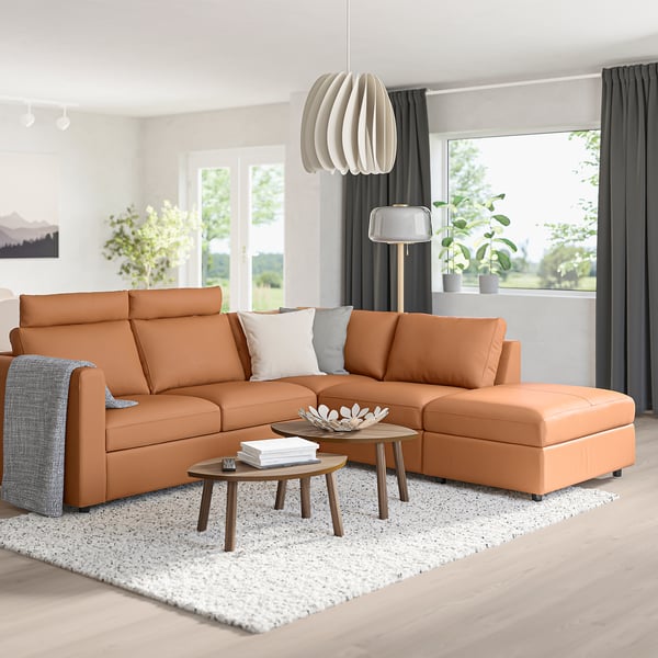 Modern living room with orange VIMLE sectional sofa, foam cushions, coffee tables, rug, and plants.
