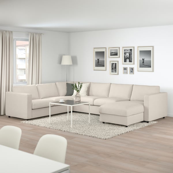 Modern living room with VIMLE sectional, coffee table, beige rug, curtains, and black-and-white photos.