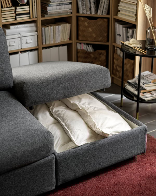 Grey VIMLE sofa with white cushions, wool-like fabric, clean design, built-in storage.