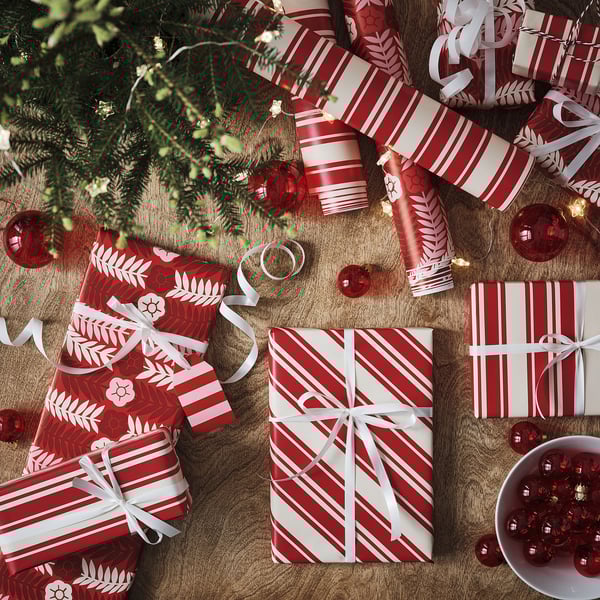 Top view of wrapped gifts in red and white paper, adorned with ribbons and bows, ready for christmas.
