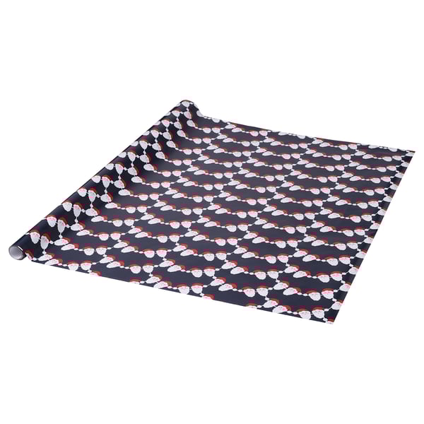 Black gift wrap with white santa faces and red hats, rolled and partially unrolled.