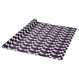 Black gift wrap with white santa faces and red hats, rolled and partially unrolled.