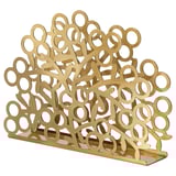 Gold VINTERFINT napkin holder, circular cutouts, stainless steel shiny finish; elegant, decorative table accessory.