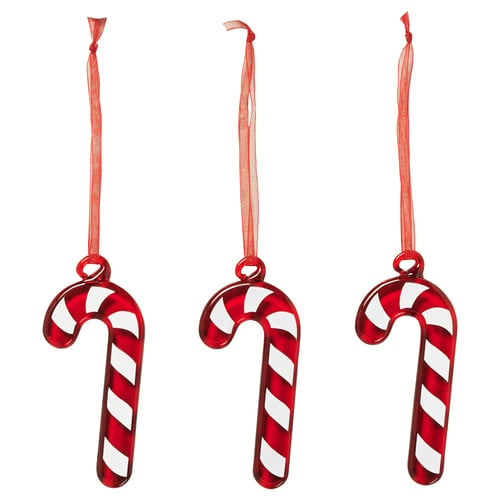 Three red and white striped candy cane-shaped christmas ornaments hang from ribbons.