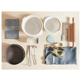 Kitchen items: bowls, cloths, pan, tools, roller, cup, whisk, tongs, ribbon.