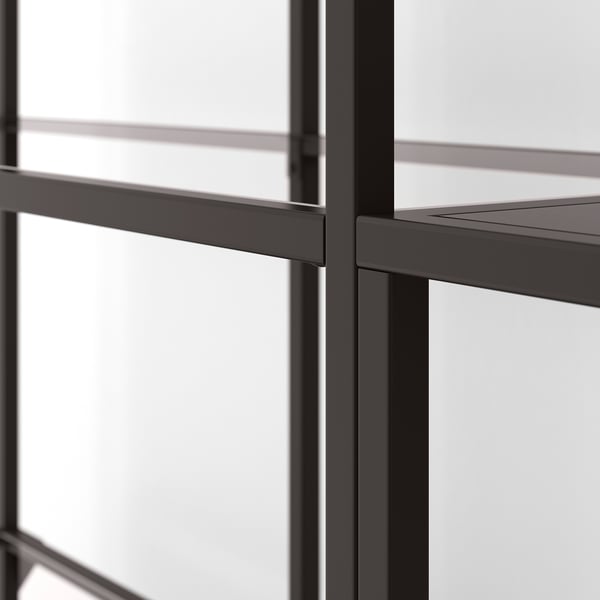 Modern metal shelf with clear glass panels, well-crafted for stability and style.