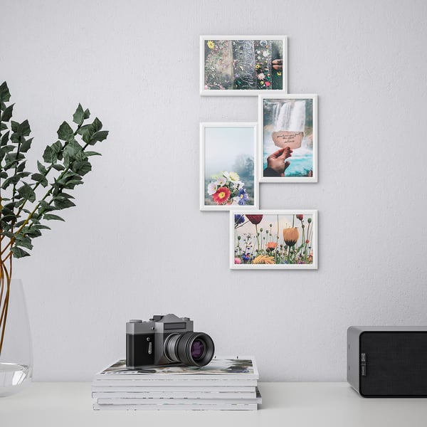 Minimalist wall art with four photos, camera, magazines, speaker, and plant.