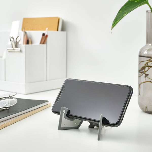Black phone stand, smaller than pen.