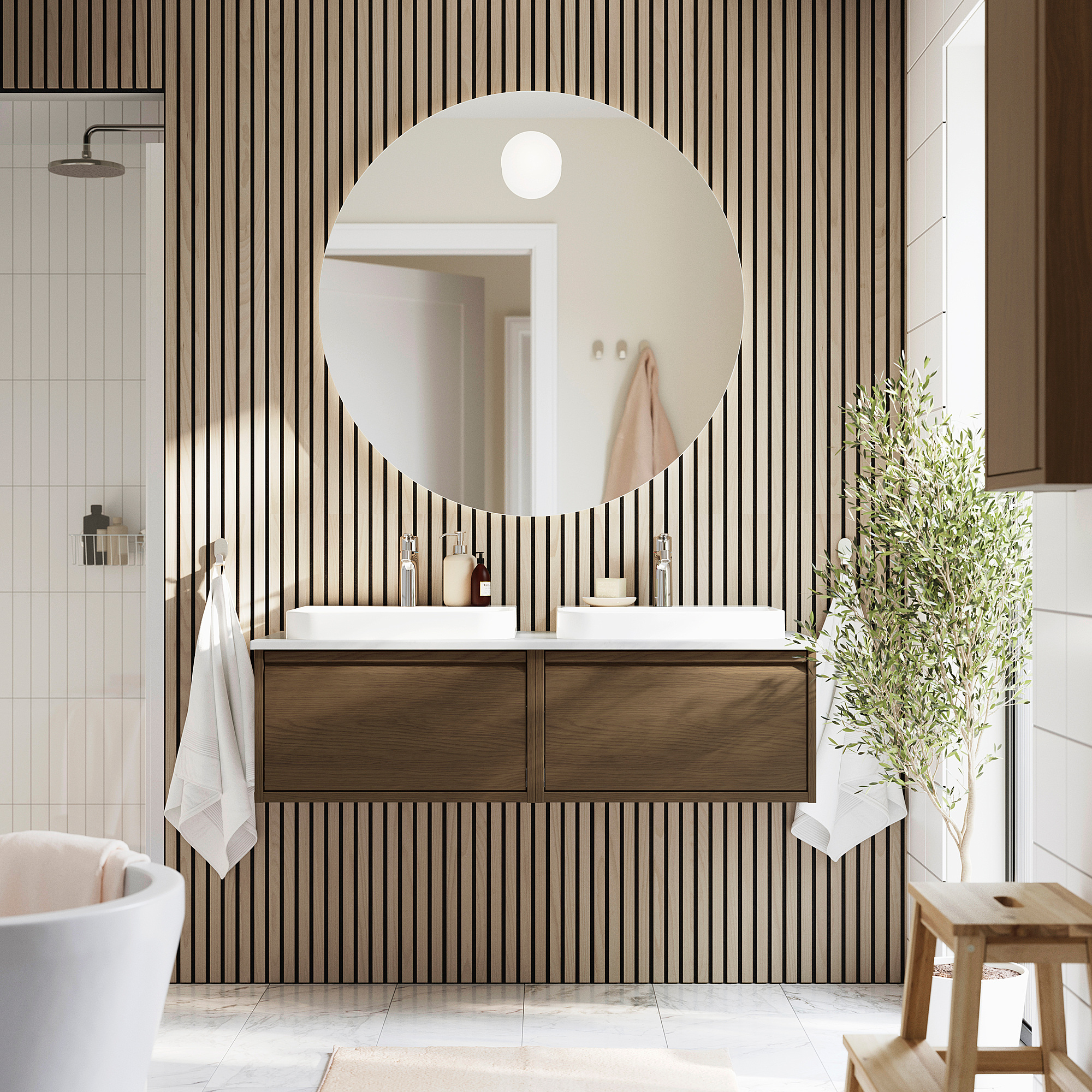 Moderner Badezimmer-Doppelwaschtisch ÄNGSJÖN mit dunklen Holzschränken, Marmorarbeitsplatte und rundem Spiegel. Platzsparendes Design mit schlanken Griffen.