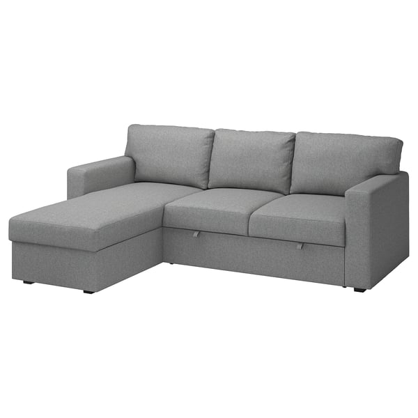 Ein graues BÅRSLÖV-Schlafsofa mit einer Chaiselongue. Es hat weiche Formen und große Kissen, perfekt zum Entspannen.