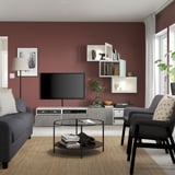 Modernes Wohnzimmer mit kastanienbraunen Wänden, grauen Möbeln, BESTÅ TV-Ständer und Wandschränken.