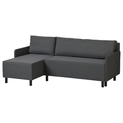 Ein dunkelgraues BRUKSVARA L-förmiges Schlafsofa. Es hat ein modernes Design mit sich verjüngenden schwarzen Beinen und eingebautem Stauraum für mehr Komfort.