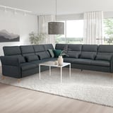 Modernes Wohnzimmer mit grauer FAMMARP-Sektion, weißem Couchtisch, Pendelleuchte und großem Fenster.