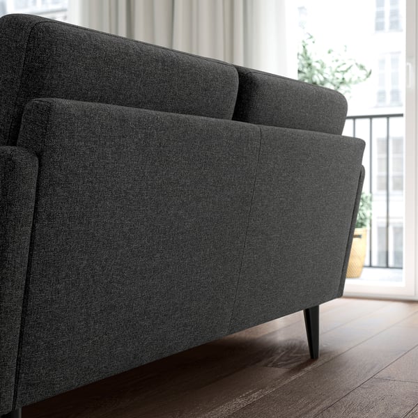 Modernes graues GRILLSTORP-Sofa, schlankes Design, dunkler Holzboden, Blick auf die Stadt. Bequemes, kompaktes Sofa, perfekt für kleine Räume.