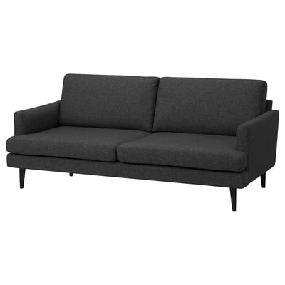 Ein dunkelgraues GRILLSTORP 3-Sitzer-Sofa mit schlankem Design, Holzbeinen und bequemen Kissen.