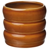 Goldbraunes Pflanzgefäß aus Feinsteinzeug mit geriffeltem Design.