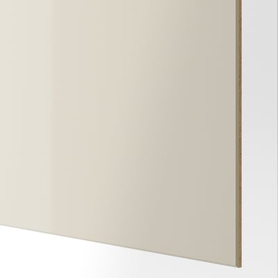 Glatte, hochglänzende beige Oberfläche, modernes, glattes Finish, das aus nächster Nähe gezeigt wird.
