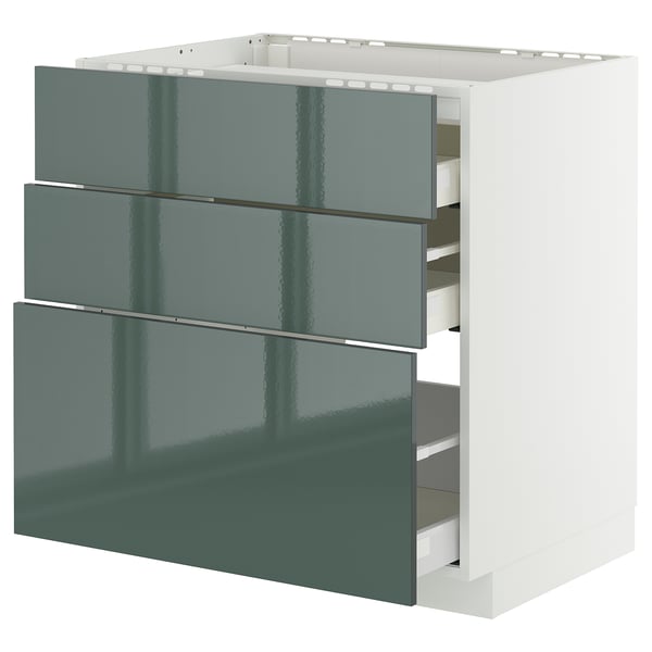 Ein hochglänzender grau-grüner METOD-Schrank mit drei ausgezogenen Schubladen in modernem Design.