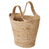 Korb aus natürlicher Jute mit zwei Griffen, geflochten in zylindrischer Form. Ideal zur Aufbewahrung, rustikales Design.