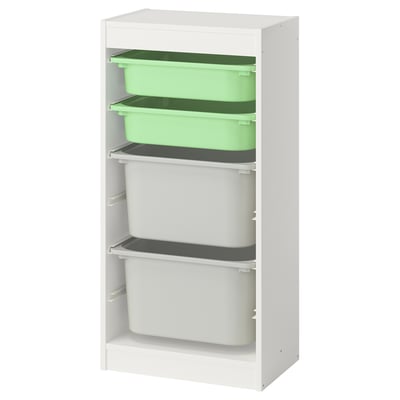 Weißer IKEA TROFAST Stauraum mit grün-weißen Behältern für Kinderspielzeug.