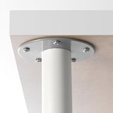 Close-up of a metallic table leg with adjustable feet, secured by mounting screws, against a light surface.
